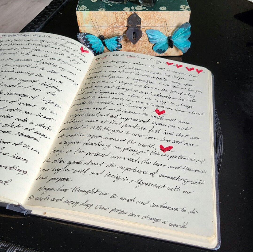 Open notebook with handwritten notes and a pen on a desk