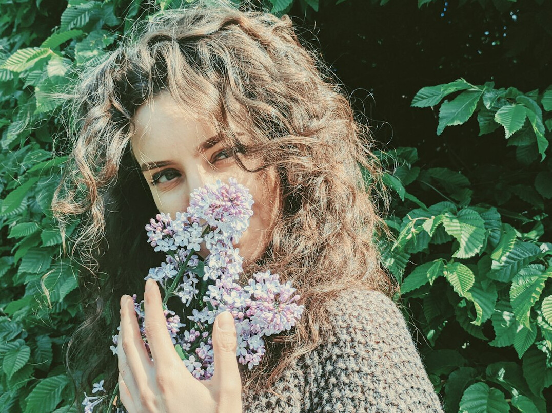 Portrait of a smiling young woman with curly hair